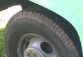 Filename HD-1989-Seven-Ton-Truck-for-Sale_FrontLeftTire.JPG. Closeup image of the Left-Front new tire, showing that this is the LT235/85R16 E [E is the heaviest load rating available for this size tire].