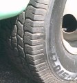 Filename HD-1989-Seven-Ton-Truck-for-Sale_FrontRightTire.JPG. A close-up photo of the Right-Front tire, showing that the tread is like new  less than 10,000 miles on these tires.