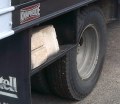 Filename HD-1989-Seven-Ton-Truck-for-Sale_RR-Tire-Closeup.JPG. Another close-angle shot of the Right-rear corner of this truck, with cinder blocks loaded into the under-bed carrier boxes.